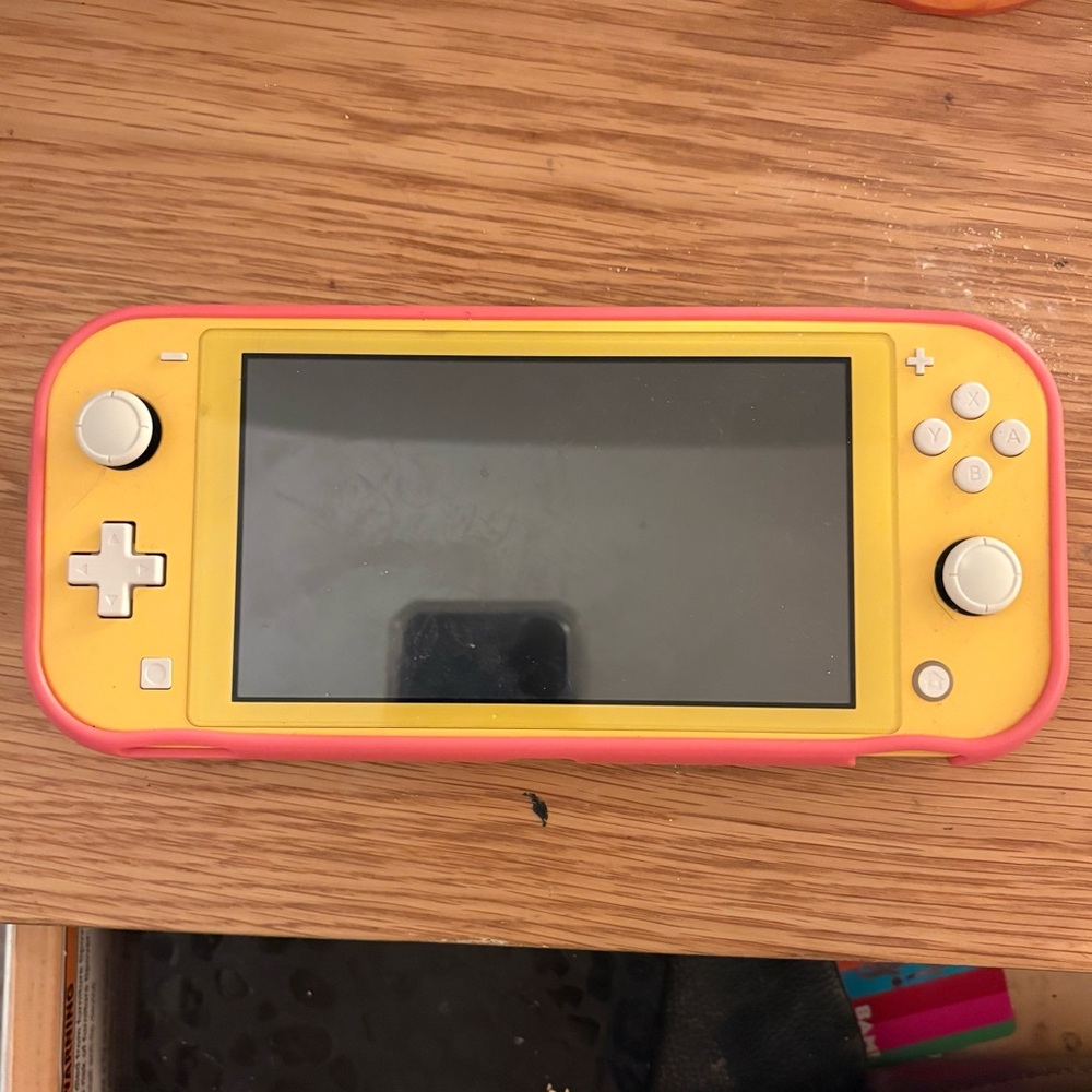 Yellow Nintendo Switch Lite (Comes with pink protective case)